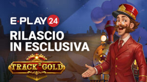 Promo banner for E-Play24 announcing 'RILASCIO IN ESCLUSIVA' for Track Gold, with a cartoon conductor beside a treasure chest at night-time