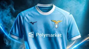 Light blue soccer jersey with sponsor 'Polymarket' and a gold eagle crest on the chest, against a smoky blue background.