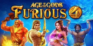 Slot online, mega vincita su Sunbet da 38.000 euro Game cover for 'Age of the Gods: Furious 4' with four mythic heroes—an armored warrior, archer, a pink-dressed goddess, and a muscular mythic fighter—standing in a blue/orange magical glow; title and subtitle visible.