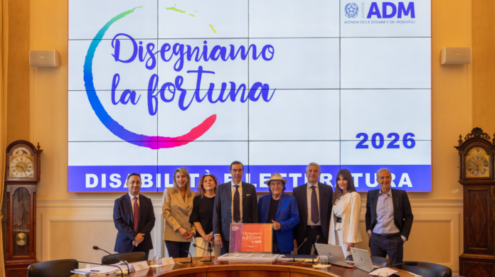 ADM disegniamo la fortuna 2026 Group of eight professionals posing and smiling in a conference room in front of a large screen with Italian text and the year 2026.