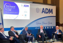 Stati Generali ADM, Rella (vicepresidente Logista): “La filiera del tabacco vale 24,5 miliardi di euro. Garantire stabilità a imprese e lavoratori” Panel of five men in suits seated on stage at an ADM event, with a large ADM banner and flags in the background.