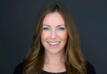 Gioco online, World Gaming nomina una nuova direttrice per iGB L!VE London e iGB Affiliate Barcelona Smiling woman with blue eyes and long light brown hair against a dark gray background.