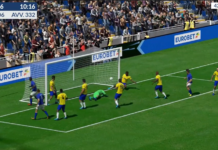 Eurobet porta l’Italia ai Mondiali: arriva “Mondiali Virtual 2026”, l’emozione del calcio in soli 120 secondi Soccer match moment near the goal: a goalkeeper dives to save a shot as yellow and blue players react.